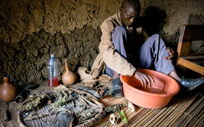 Traditional healer performs a ceremony in a Ugandan village